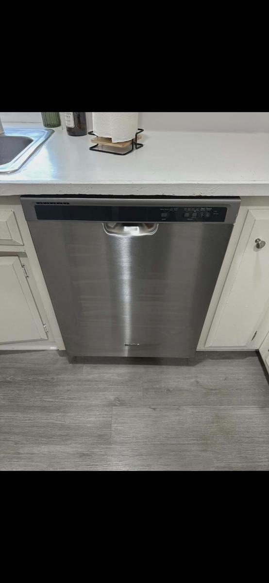 Stainless steel dishwasher installed in a kitchen