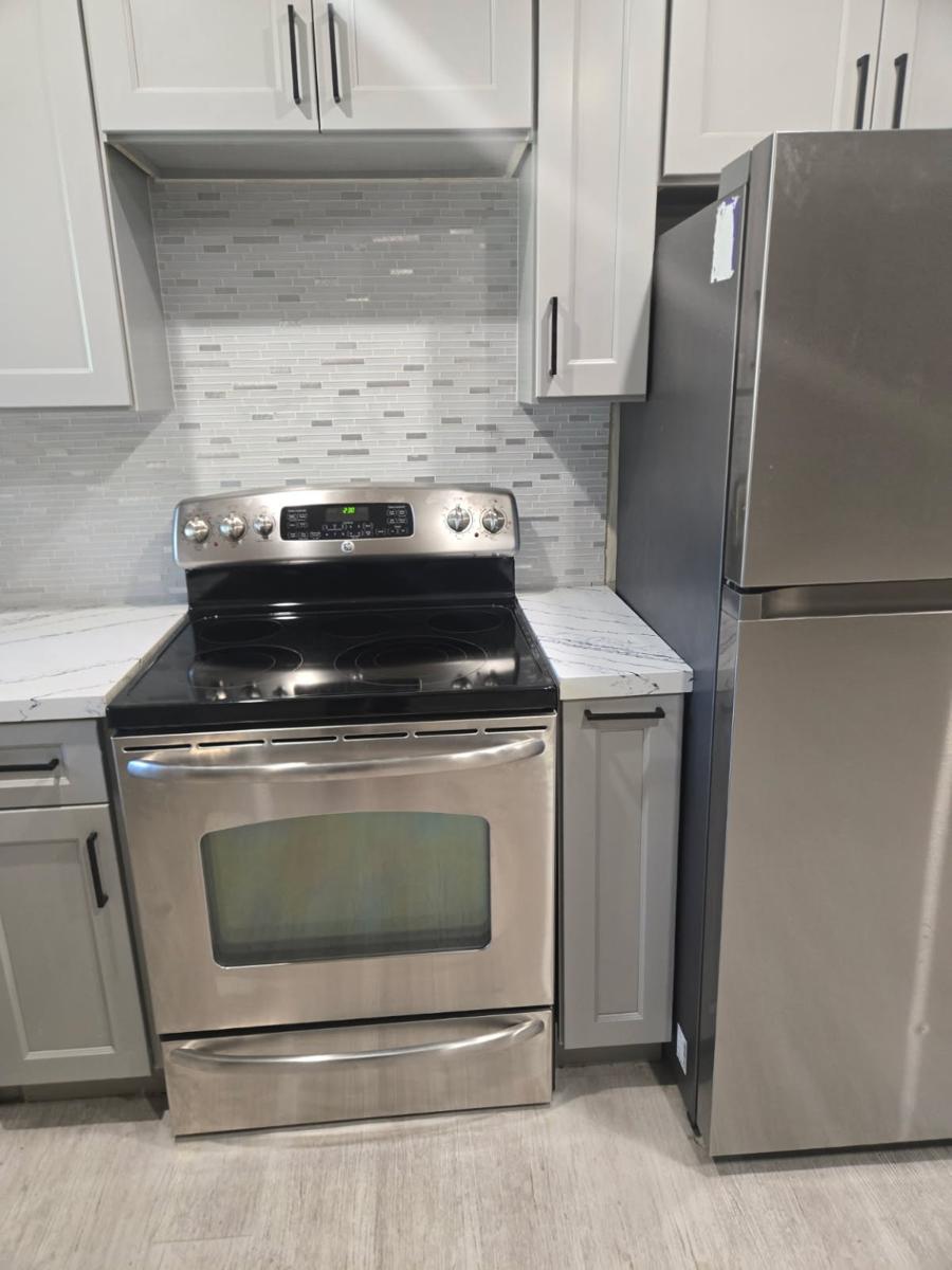 Stove and refrigerator in a finished kitchen